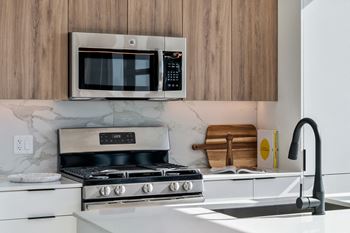 a kitchen with a microwave and a stove and a sink